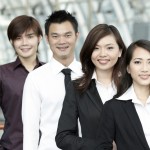 Asian Business colleagues standing in a row and smiling